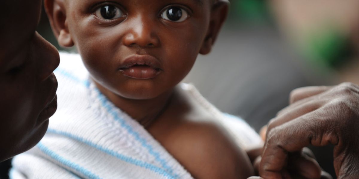 Photo by Julian Harneis - A child being vaccinated against measles in Rwanda, 2008. CC BY-SA 2.0